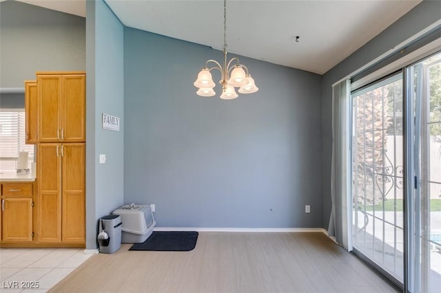 interior space featuring an inviting chandelier and light hardwood / wood-style flooring