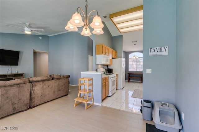 kitchen with white appliances, lofted ceiling, ceiling fan with notable chandelier, and hanging light fixtures