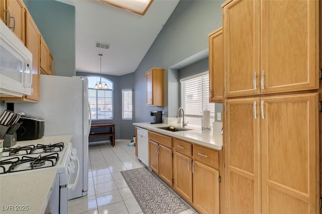 kitchen featuring light tile patterned flooring, decorative light fixtures, sink, a healthy amount of sunlight, and white appliances