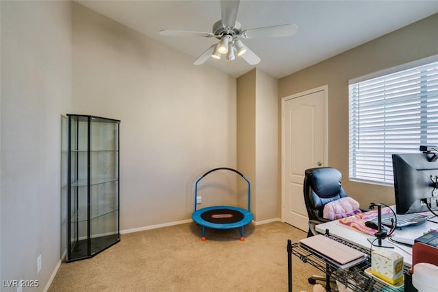 home office featuring light carpet and ceiling fan