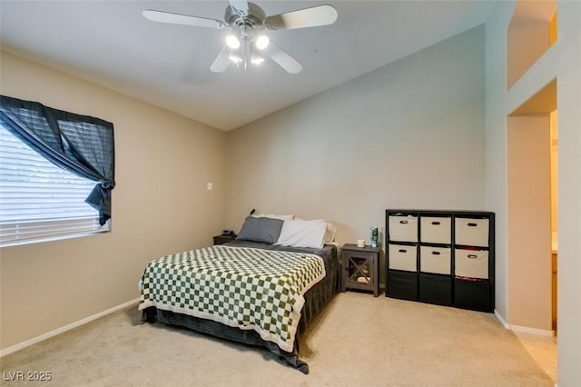 carpeted bedroom with ceiling fan and vaulted ceiling