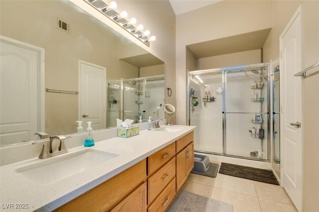 bathroom featuring vanity, a shower with door, and tile patterned floors