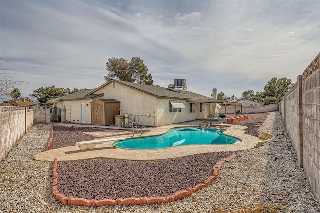 view of pool with a diving board, cooling unit, and a patio area