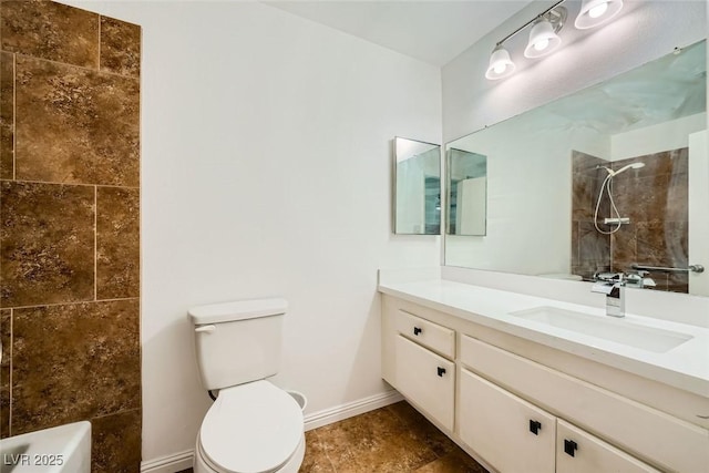 bathroom with vanity, toilet, and a tile shower