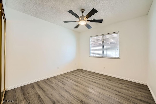 spare room with ceiling fan, wood-type flooring, and a textured ceiling