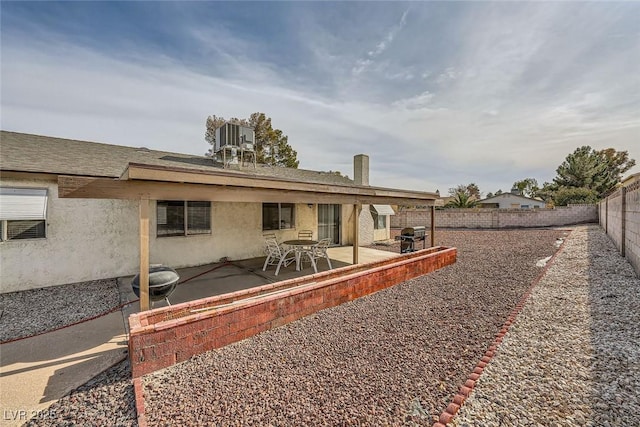 rear view of property with a patio area and central air condition unit