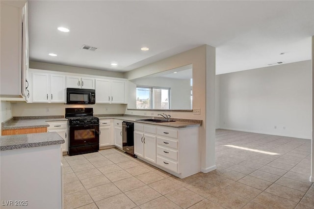 kitchen featuring white cabinetry, sink, light tile patterned floors, and black appliances