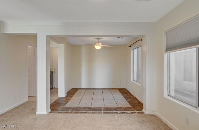 tiled empty room with crown molding and ceiling fan