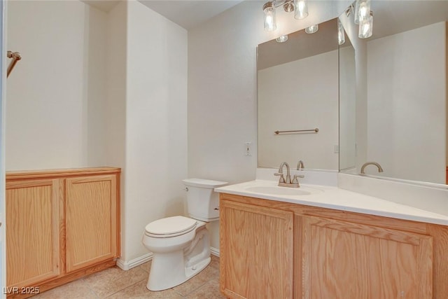 bathroom featuring tile patterned floors, vanity, and toilet