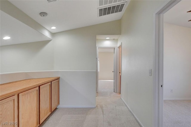 hall featuring light carpet and lofted ceiling