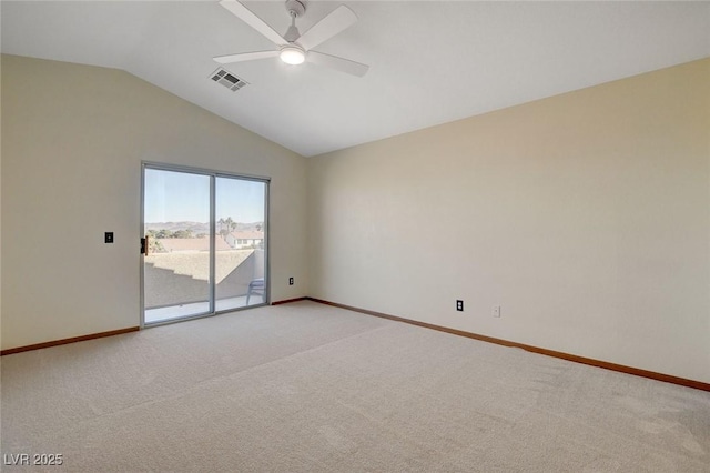 carpeted empty room with vaulted ceiling and ceiling fan