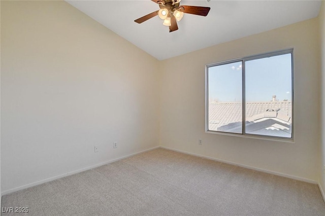 carpeted spare room featuring ceiling fan and lofted ceiling