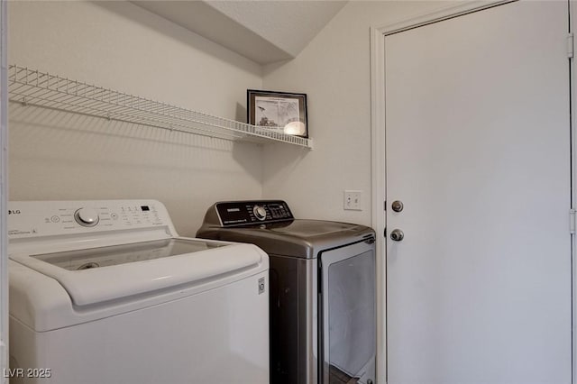 clothes washing area featuring washing machine and dryer