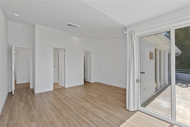 empty room featuring light hardwood / wood-style floors and a wealth of natural light