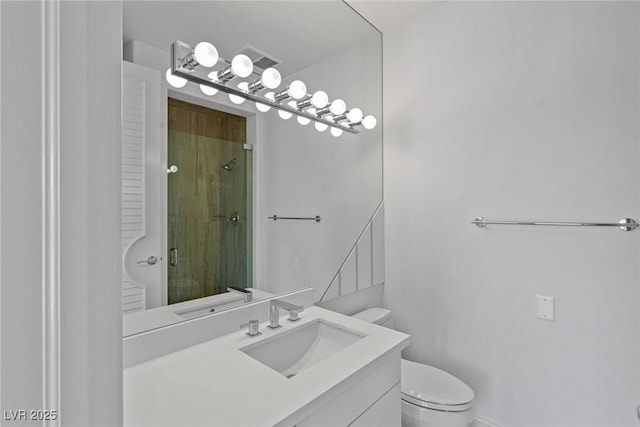 bathroom featuring vanity, toilet, and a shower