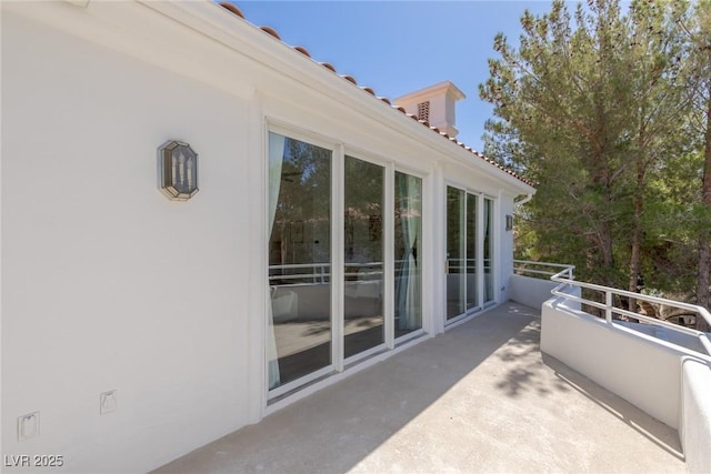 view of patio featuring a balcony