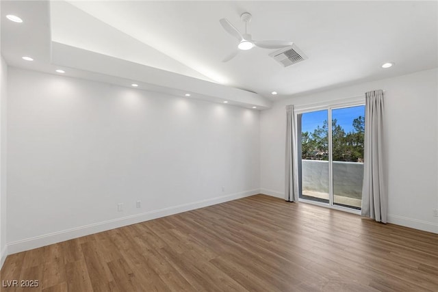 spare room featuring ceiling fan, dark hardwood / wood-style flooring, and vaulted ceiling