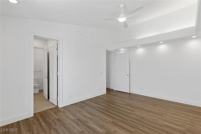 empty room featuring hardwood / wood-style flooring and ceiling fan