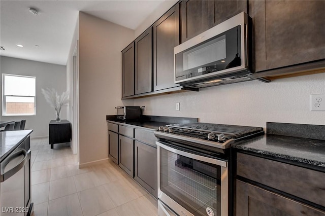 kitchen featuring dark brown cabinets, stainless steel appliances, and light tile patterned flooring