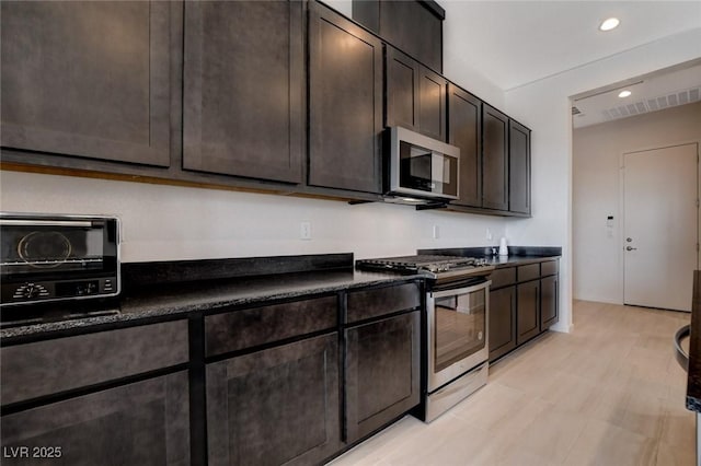 kitchen featuring dark brown cabinets and stainless steel appliances