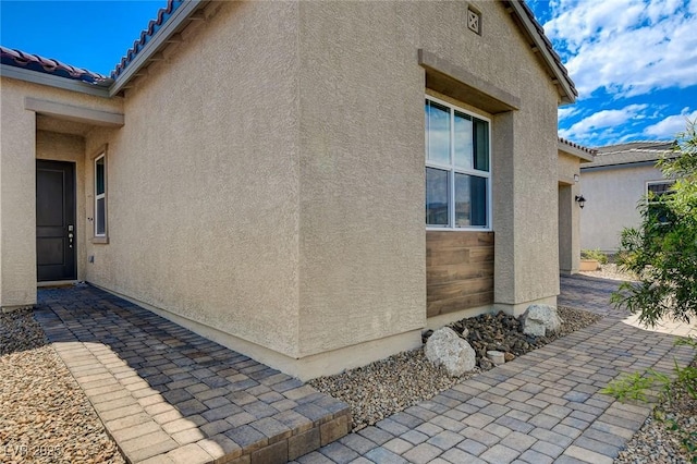 view of side of home featuring a patio