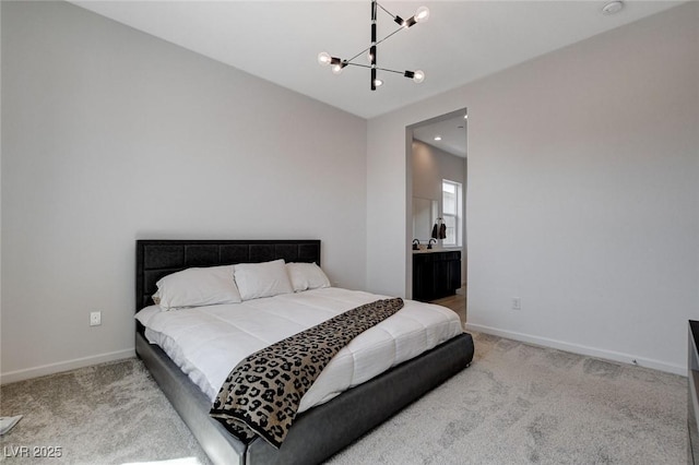 bedroom with connected bathroom, carpet flooring, and a chandelier