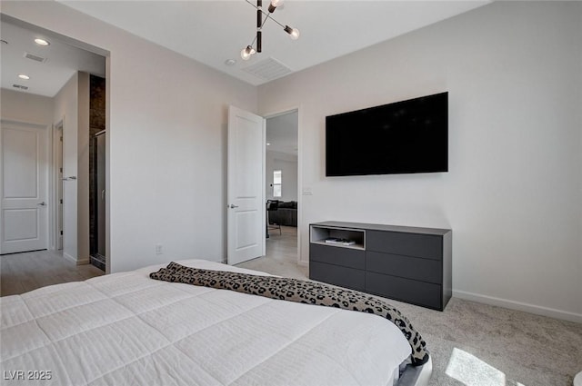 bedroom featuring light carpet and a chandelier