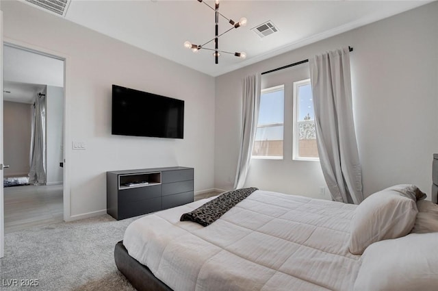 bedroom with light carpet and a notable chandelier