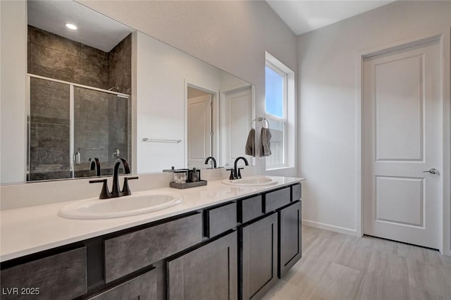 bathroom featuring walk in shower, vanity, and hardwood / wood-style floors