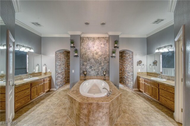 bathroom with vanity, tiled tub, and crown molding