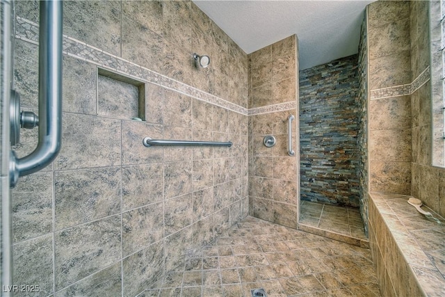 bathroom with a tile shower and a textured ceiling