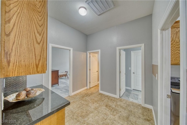 bathroom featuring washer / dryer and a textured ceiling