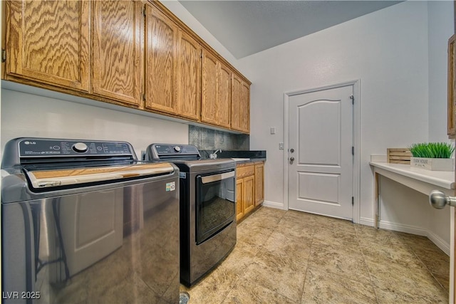 laundry room featuring cabinets, separate washer and dryer, and sink