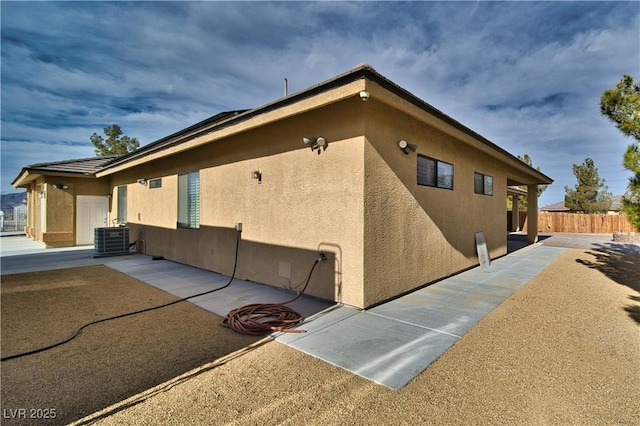 view of property exterior featuring central AC and a patio area