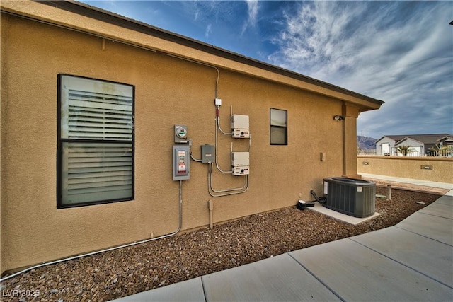 view of side of home featuring a patio area and central air condition unit