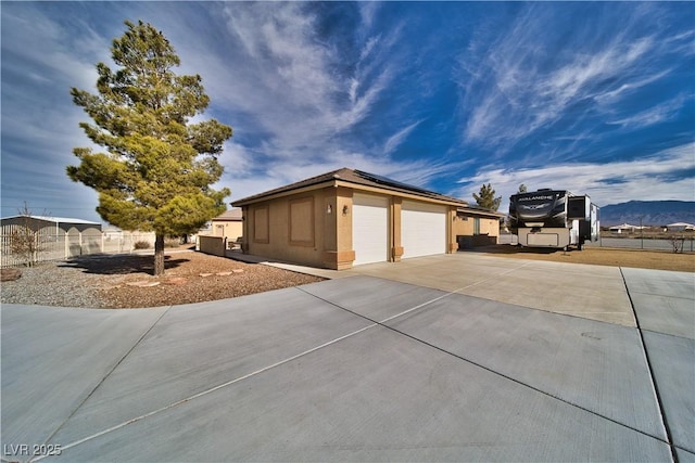 view of home's exterior featuring a mountain view and a garage