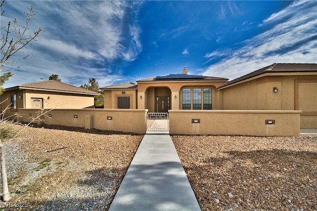 view of front of property with solar panels