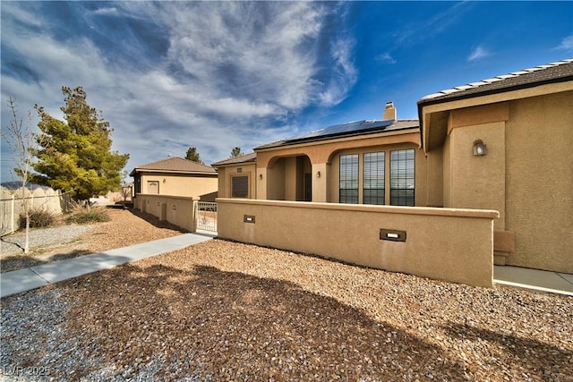 view of home's exterior featuring solar panels