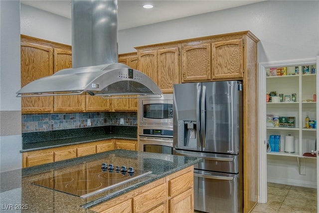 kitchen featuring light tile patterned flooring, appliances with stainless steel finishes, island exhaust hood, dark stone counters, and backsplash