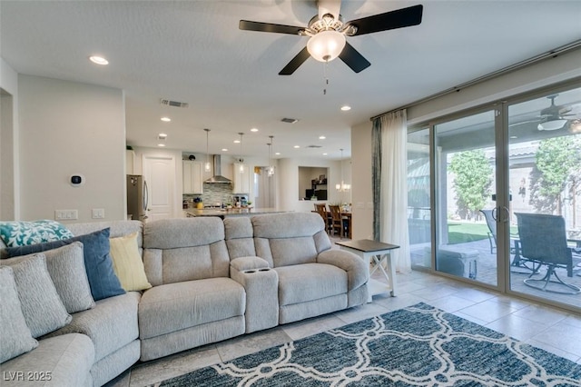 tiled living room featuring ceiling fan