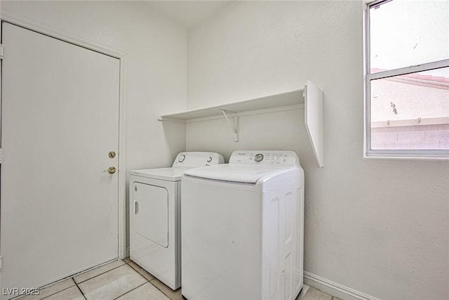 washroom with independent washer and dryer and light tile patterned floors