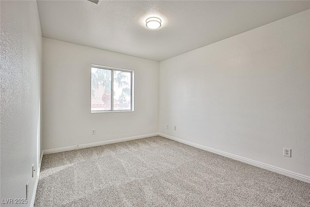 spare room with carpet flooring and a textured ceiling