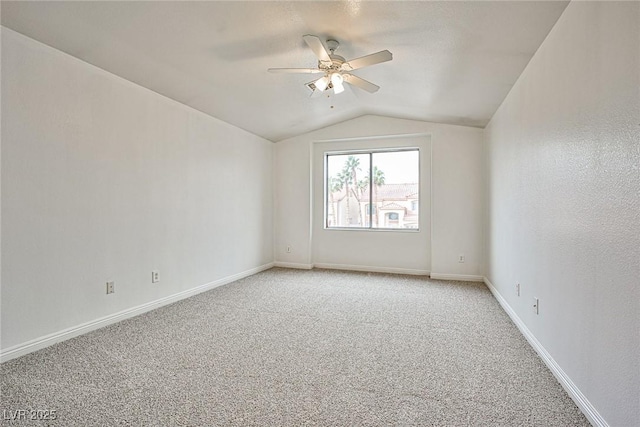 spare room with lofted ceiling, light colored carpet, and ceiling fan