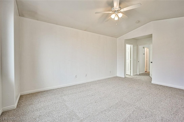 empty room with ceiling fan, light colored carpet, and vaulted ceiling