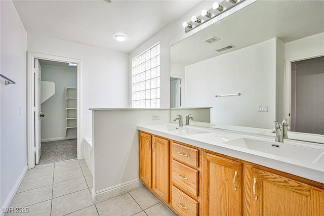 bathroom with tile patterned floors, vanity, and a bathtub