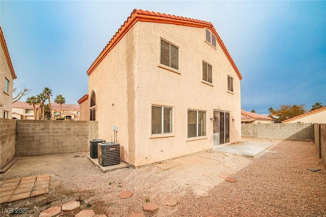 back of property with a patio area and central air condition unit