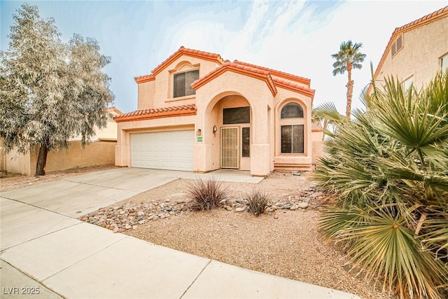 mediterranean / spanish-style home featuring a garage