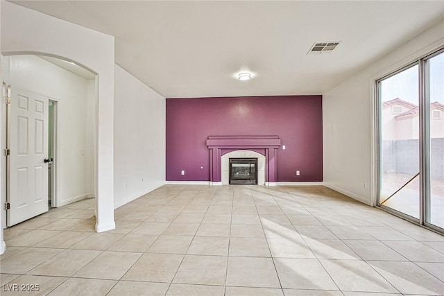 unfurnished living room featuring light tile patterned floors and a fireplace