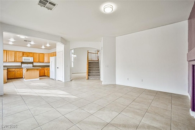 unfurnished living room with light tile patterned floors