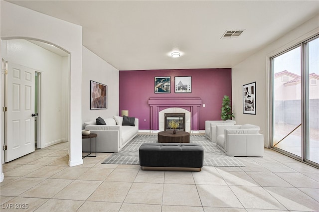 tiled living room with a tile fireplace